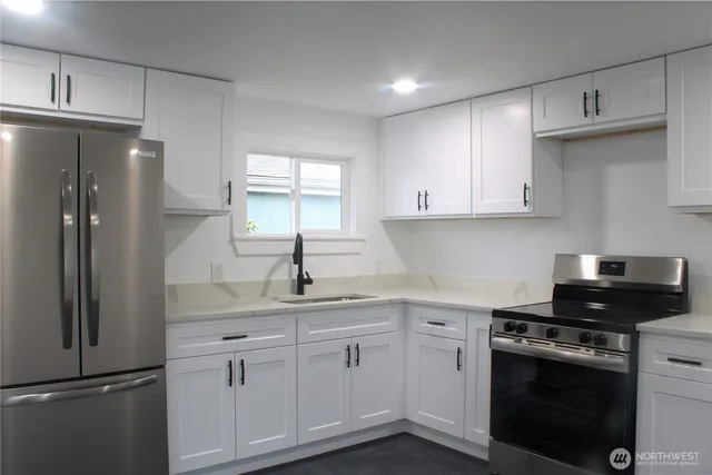 a kitchen with stainless steel appliances a refrigerator sink and stove