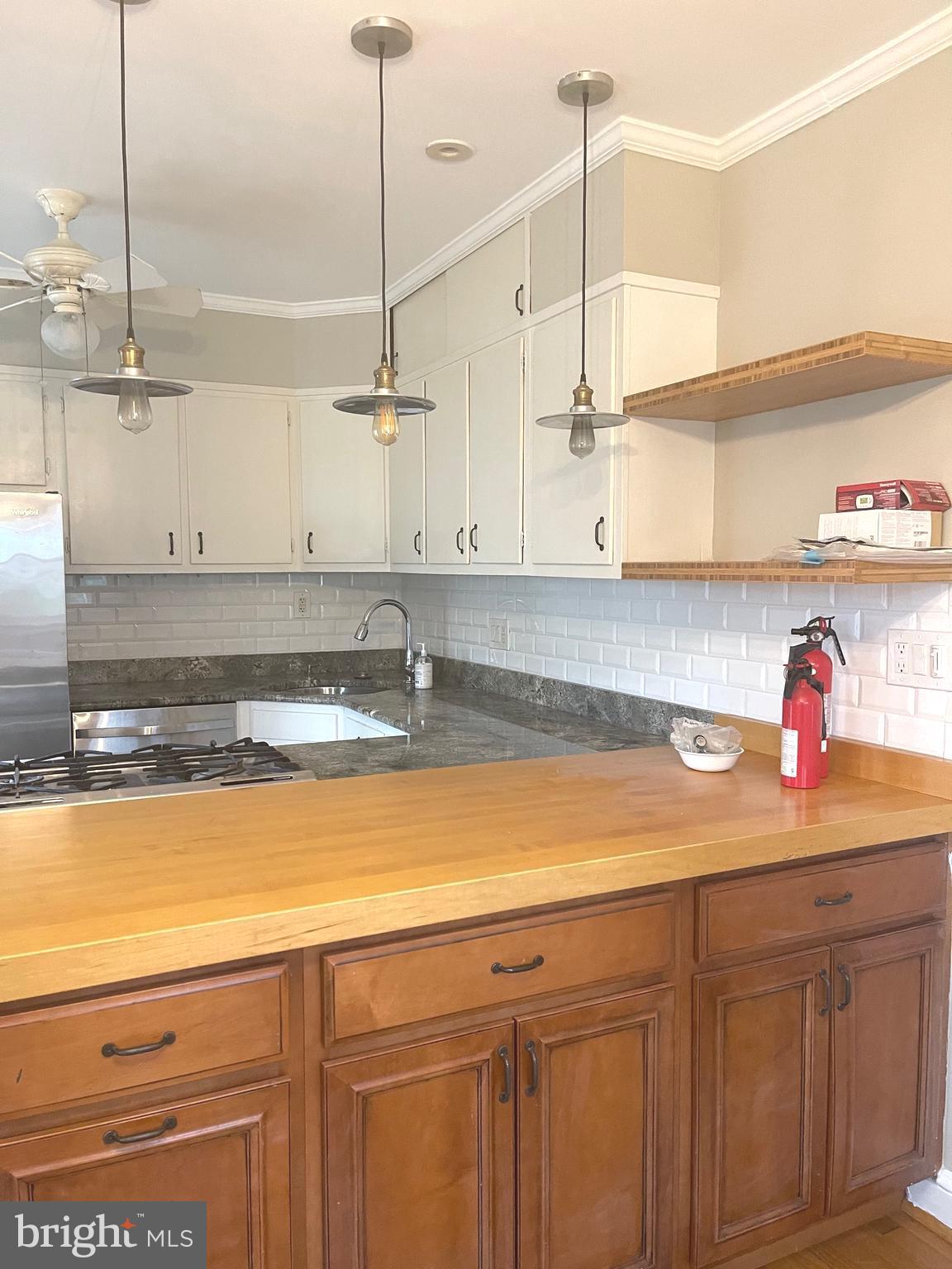 9803 Forest Grove Drive Silver Spring, MD 20902 - Photo 12 of 24 a kitchen with stainless steel appliances granite countertop a sink a refrigerator and a stove