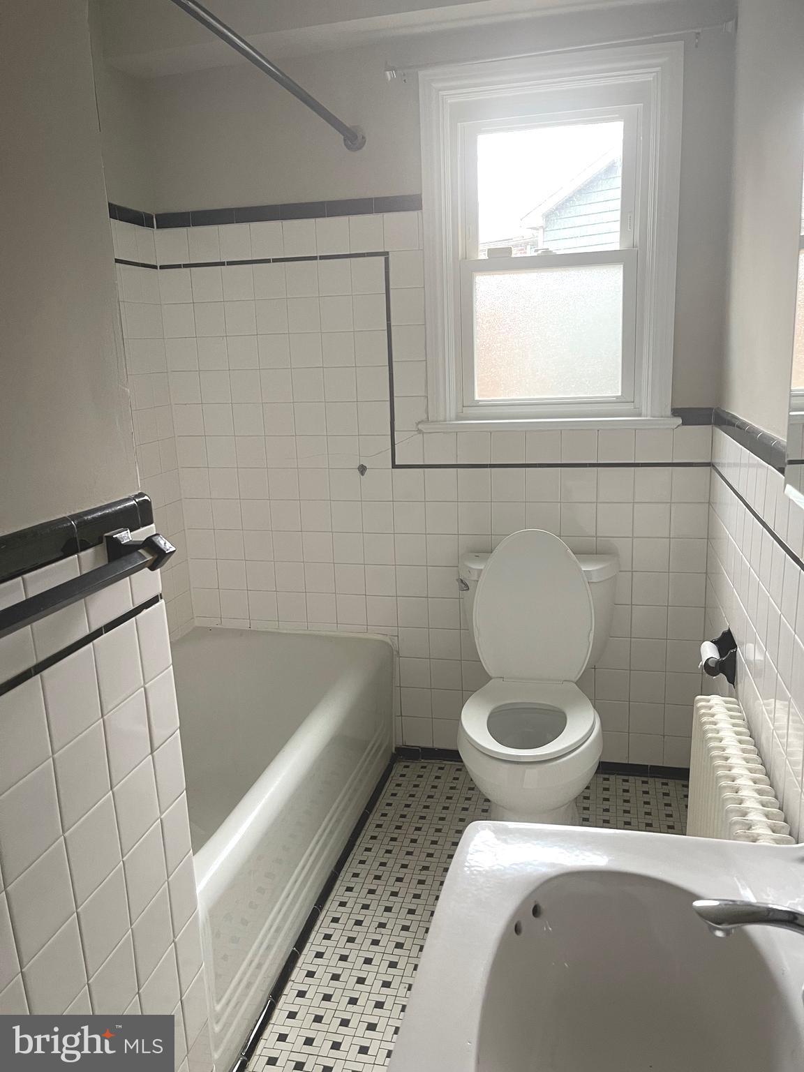 9803 Forest Grove Drive Silver Spring, MD 20902 - Photo 16 of 24 a bathroom with a toilet and a bathtub