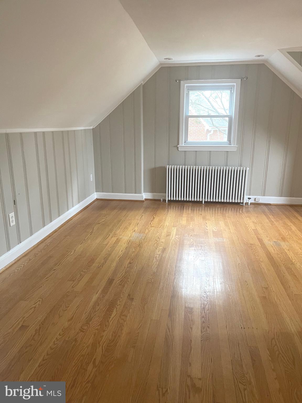 9803 Forest Grove Drive Silver Spring, MD 20902 - Photo 19 of 24 an empty room with wooden floor and windows