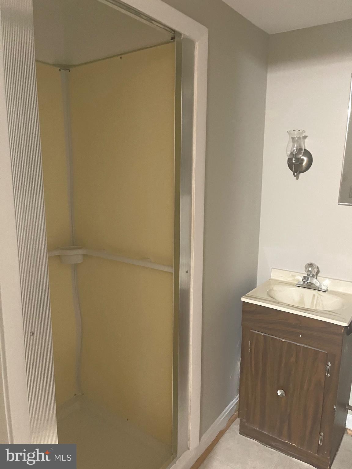 9803 Forest Grove Drive Silver Spring, MD 20902 - Photo 22 of 24 a bathroom with a sink and mirror