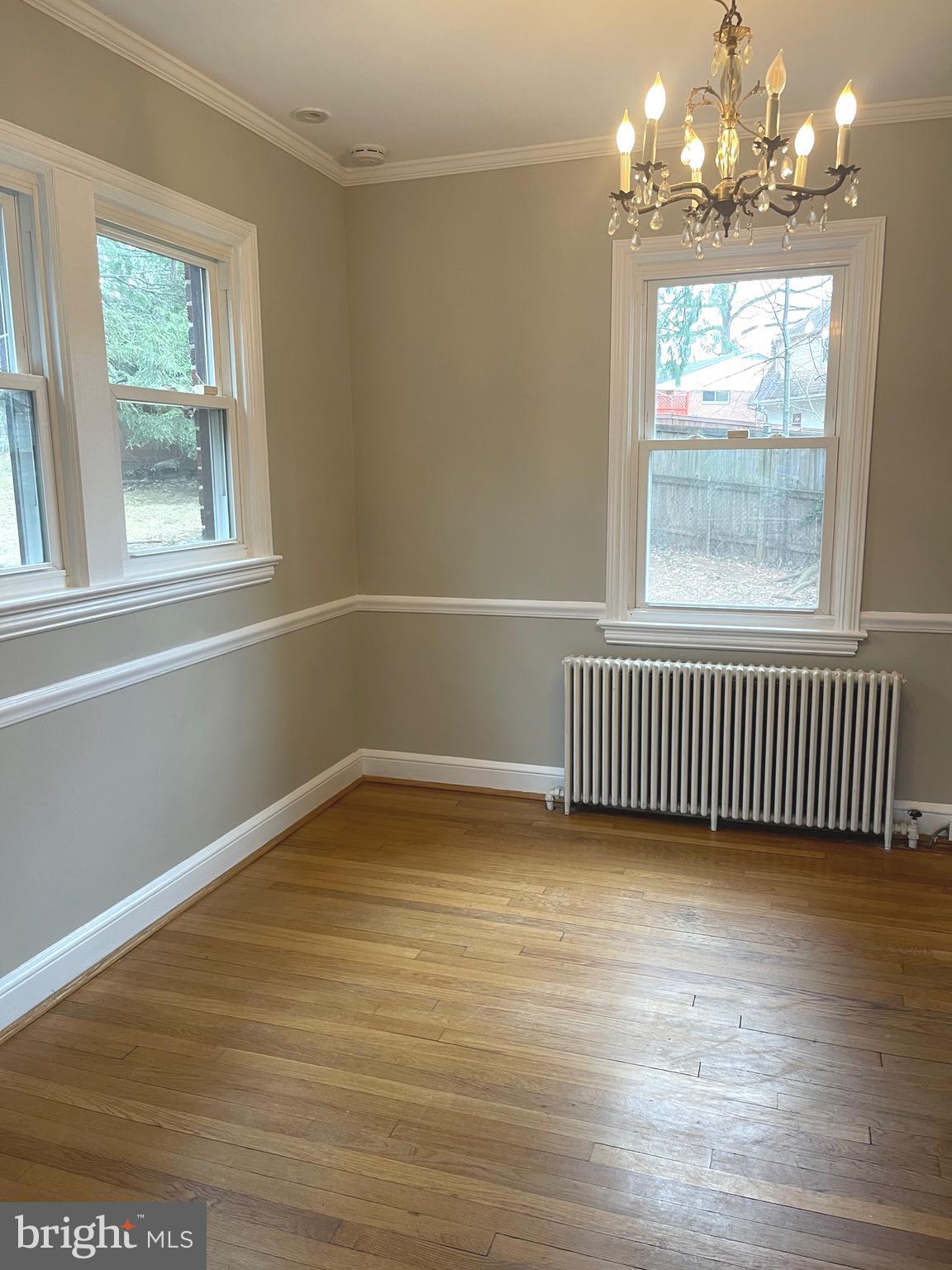9803 Forest Grove Drive Silver Spring, MD 20902 - Photo 9 of 24 a view of empty room with wooden floor and fan