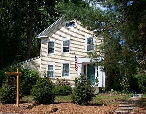 145 Dodgingtown Road Bethel, CT 06801 - Photo 1 of 1 a view of a white house next to a yard