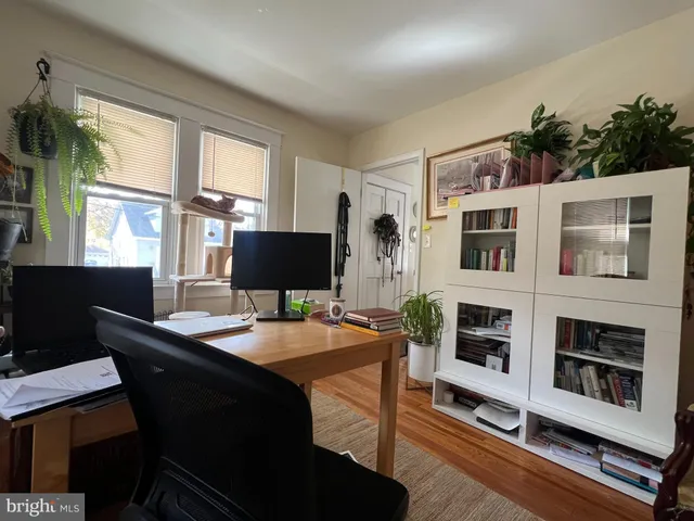 a dining room with furniture a window and a flat screen tv