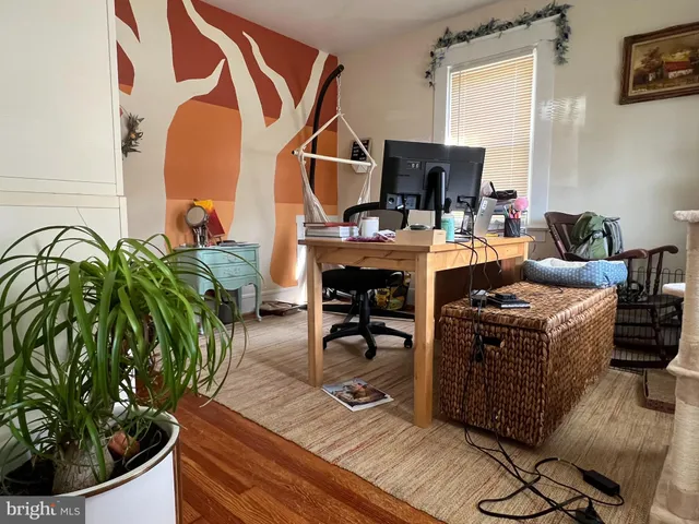 a view of living room with furniture and wooden floor