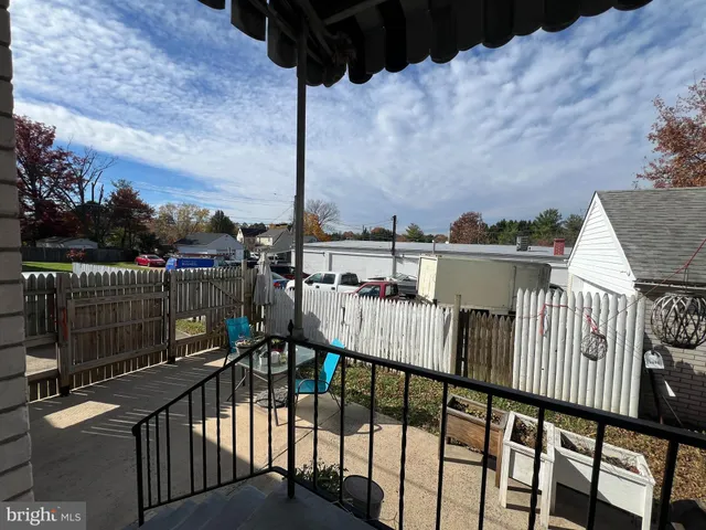 a view of a balcony with wooden fence