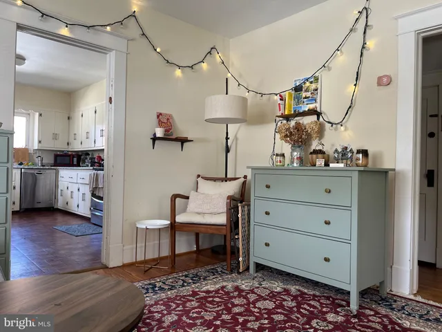 a view of a bedroom with furniture and wooden floor