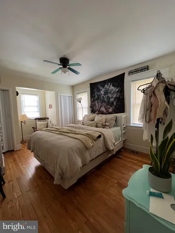 a spacious bedroom with a bed and a chandelier