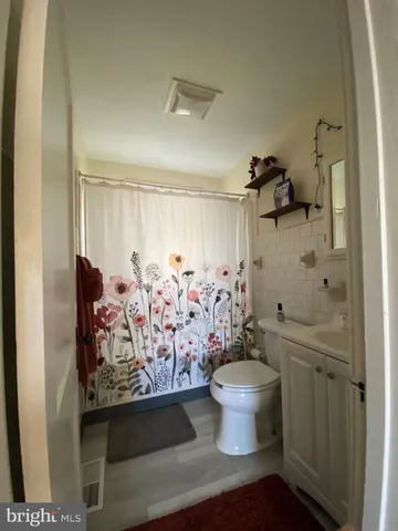 a view of a bathroom with toilet and shower