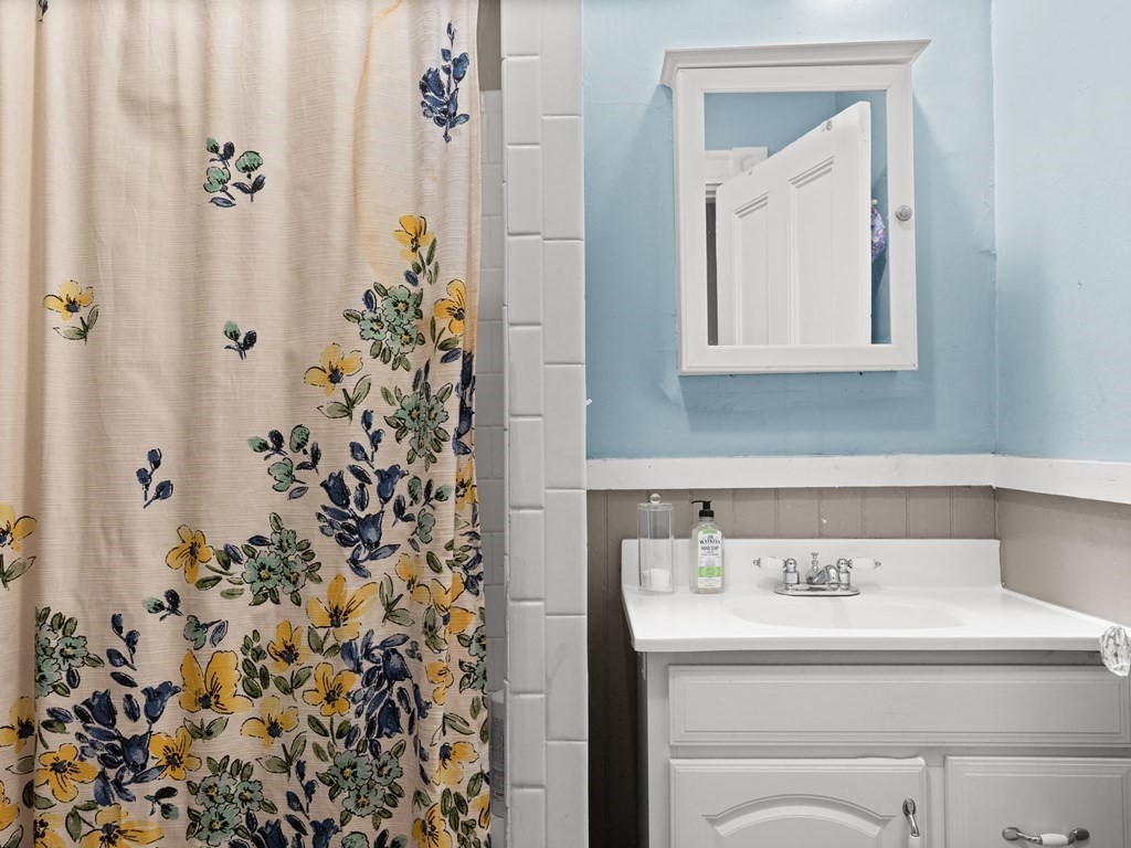 427-435 Faneuil Street, Unit R4 Boston, MA 02135 - Photo 12 of 18 a bathroom with a sink and mirror