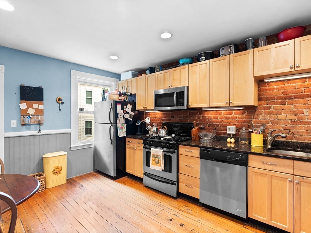 427-435 Faneuil Street, Unit R4 Boston, MA 02135 - Photo 6 of 18 a kitchen with stainless steel appliances a stove a sink a refrigerator cabinets and a window