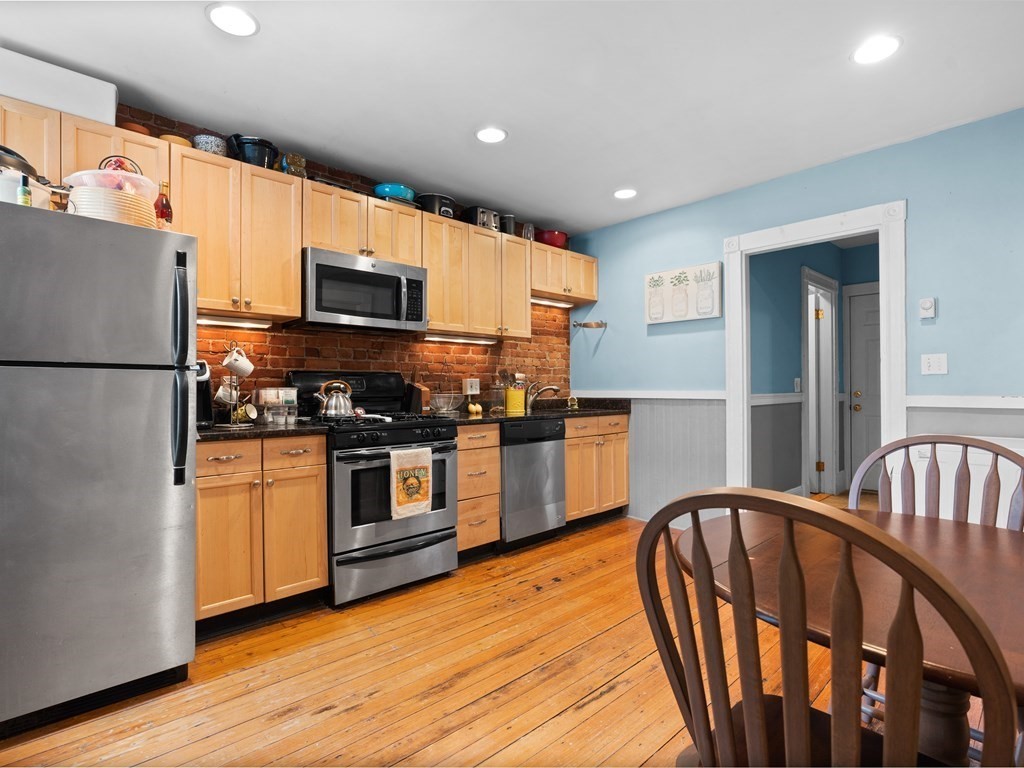 427-435 Faneuil Street, Unit R4 Boston, MA 02135 - Photo 9 of 18 a kitchen with stainless steel appliances granite countertop a refrigerator a stove top oven a sink and dishwasher