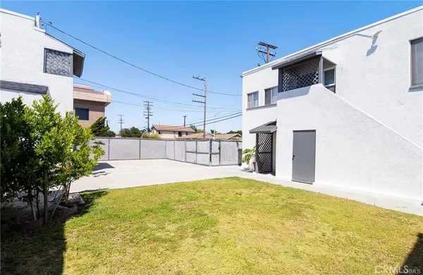 a swimming pool with yard and wooden fence