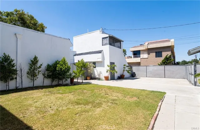 a swimming pool with yard in front of it