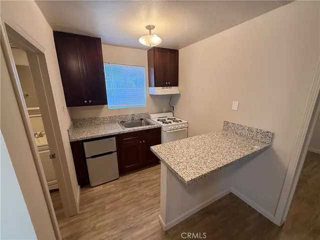 a kitchen with a stove and a refrigerator