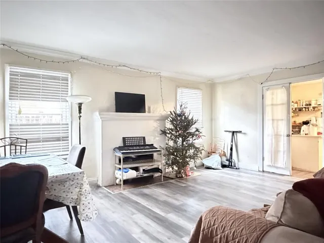 a living room with furniture a large window and a flat screen tv