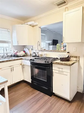 a kitchen with a stove oven and sink