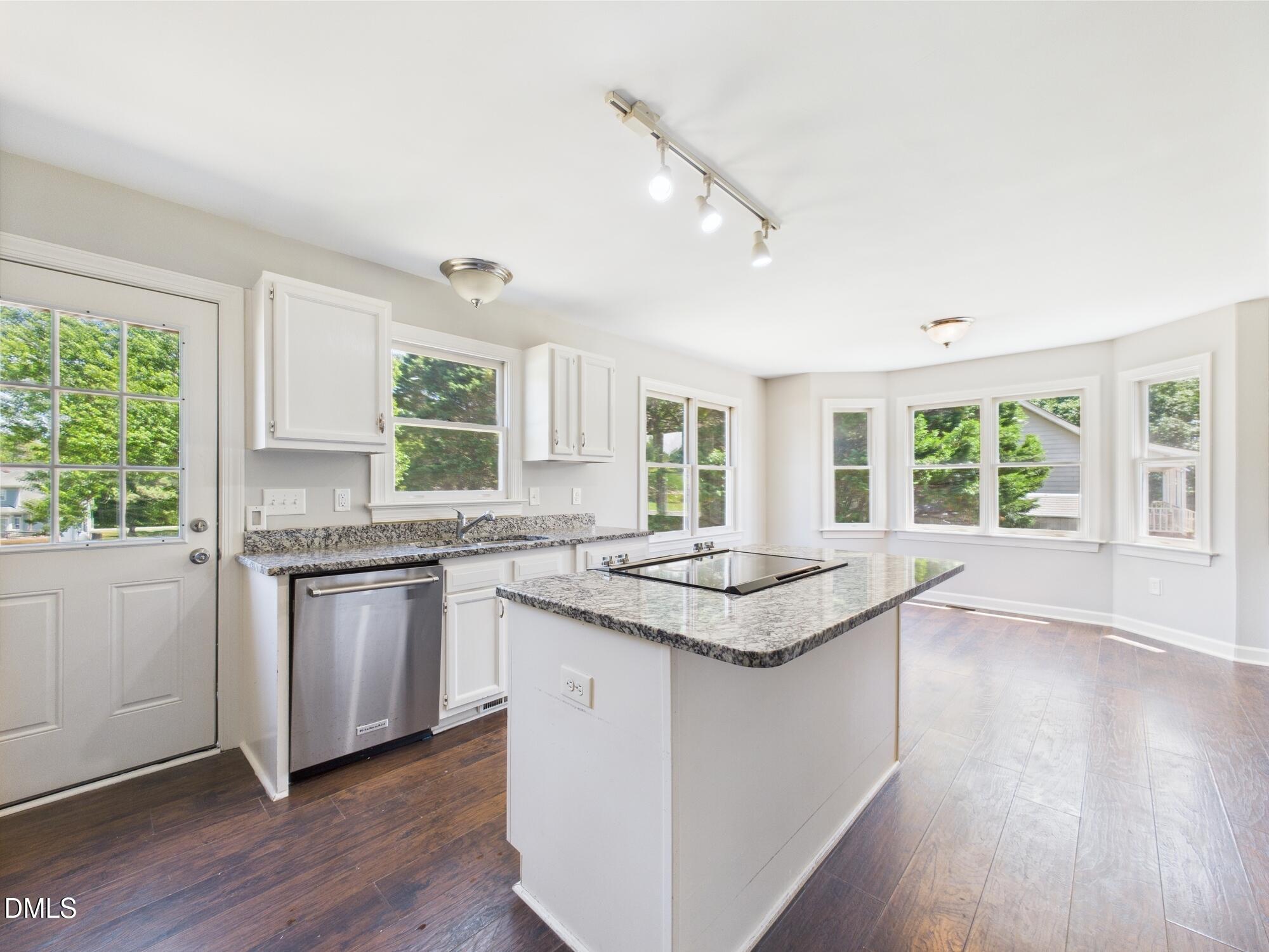 10917 Fanny Brown Road Raleigh, NC 27603 - Photo 24 of 54 a kitchen with granite countertop center island wooden floor and a sink