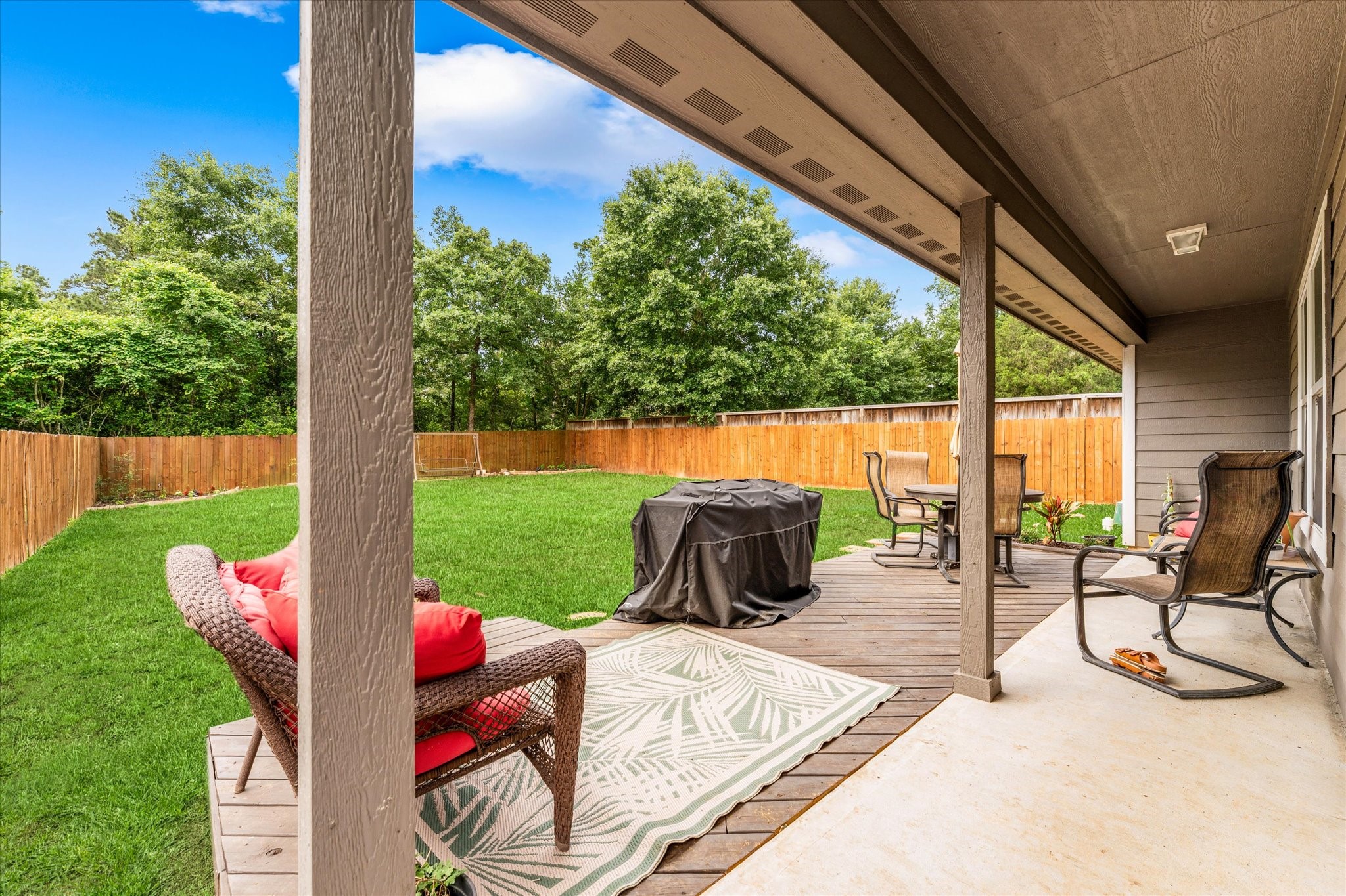 3998 Frontier Road Willis, TX 77378 - Photo 28 of 33 a view of a patio with a table chairs and a backyard