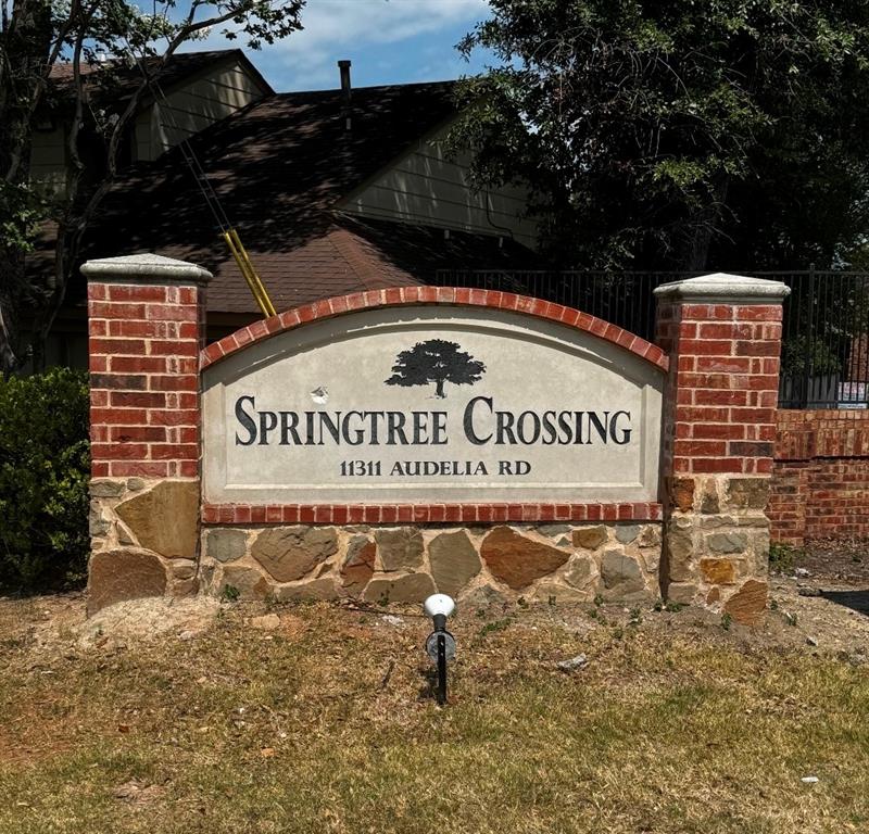 11311 Audelia Road, Unit 109 Dallas, TX 75243 - Photo 1 of 1 Springtree Crossing signage featuring a stone and brick base, arched sign panel, and wrought iron detailing