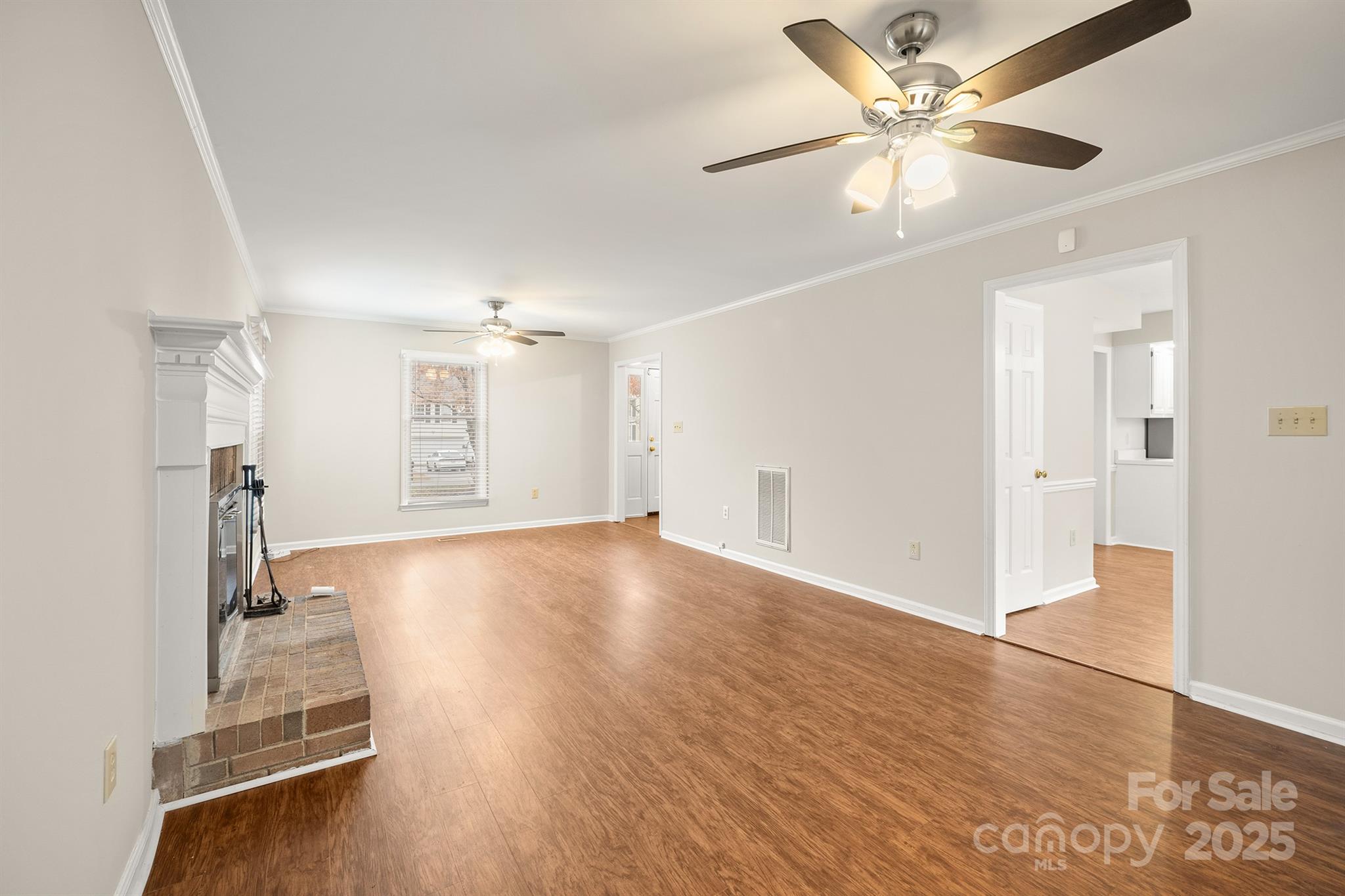 8730 Rittenhouse Circle Charlotte, NC 28270 - Photo 11 of 48 a view of an empty room with wooden floor and a ceiling fan