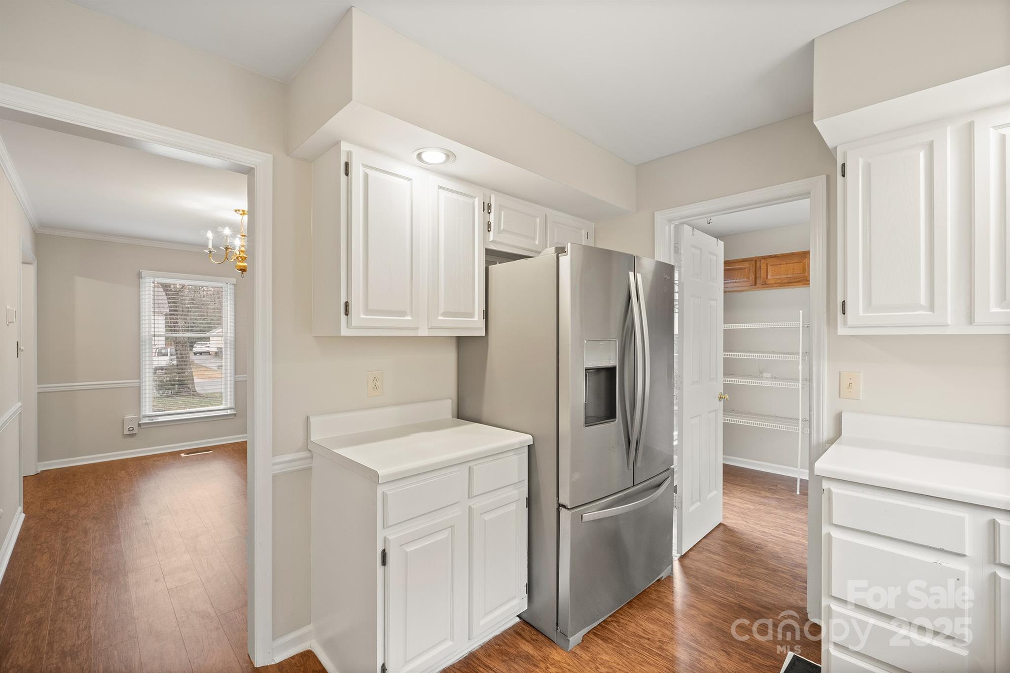 8730 Rittenhouse Circle Charlotte, NC 28270 - Photo 18 of 48 a kitchen with a refrigerator a stove top oven and wooden floor