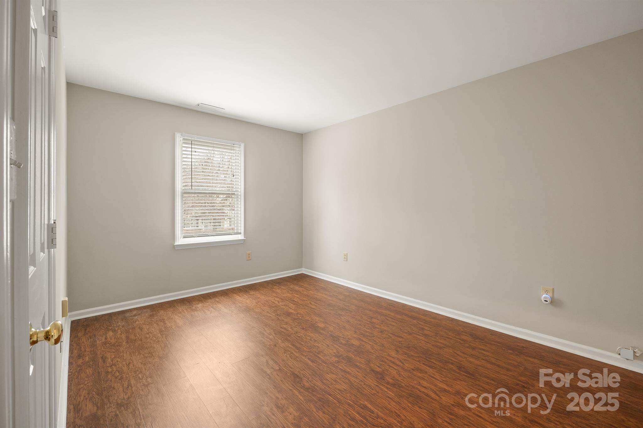 8730 Rittenhouse Circle Charlotte, NC 28270 - Photo 23 of 48 an empty room with wooden floor and windows