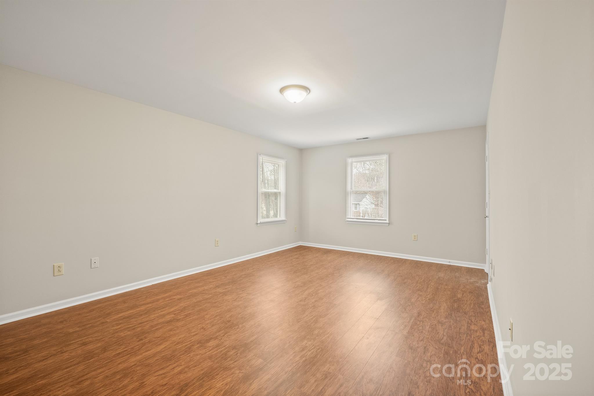8730 Rittenhouse Circle Charlotte, NC 28270 - Photo 28 of 48 an empty room with wooden floor and windows