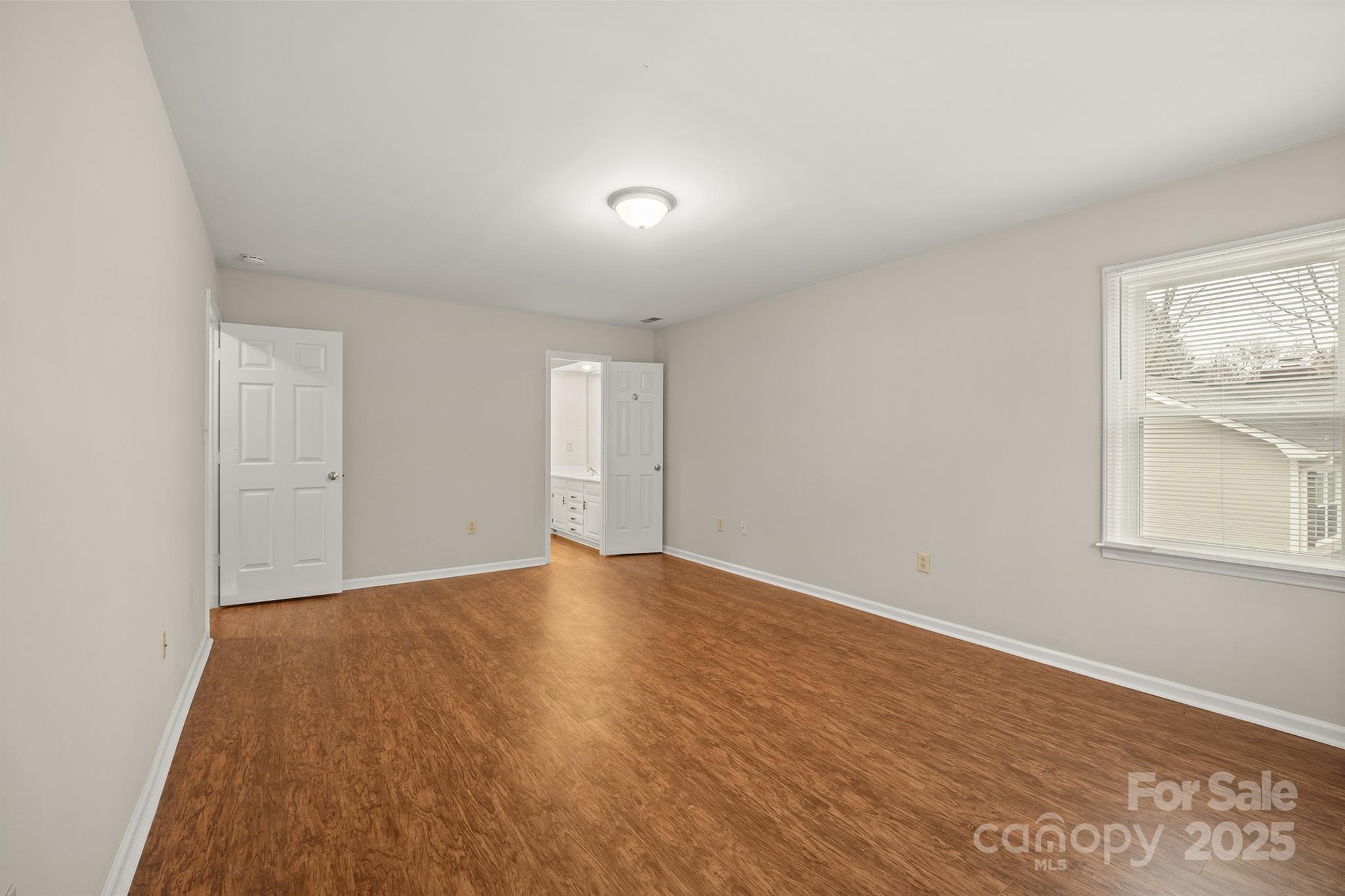 8730 Rittenhouse Circle Charlotte, NC 28270 - Photo 29 of 48 an empty room with wooden floor and windows