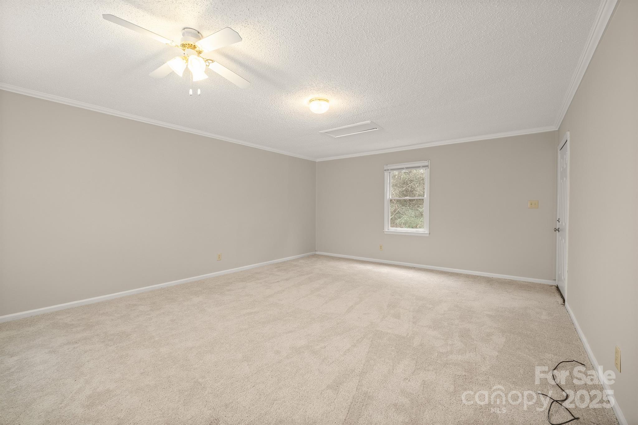 8730 Rittenhouse Circle Charlotte, NC 28270 - Photo 38 of 48 an empty room with a window and a ceiling fan