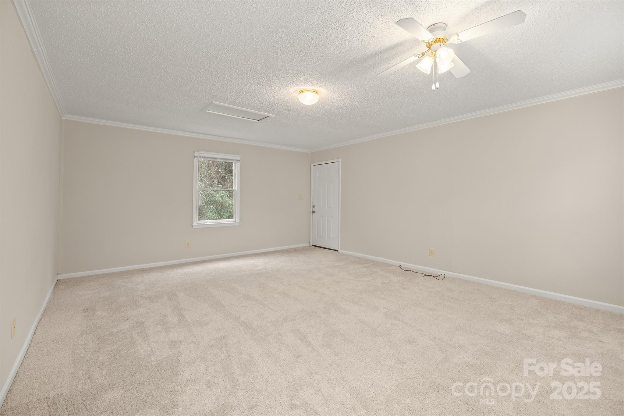 8730 Rittenhouse Circle Charlotte, NC 28270 - Photo 39 of 48 an empty room with a chandelier fan and windows
