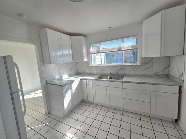 a kitchen with cabinets and window