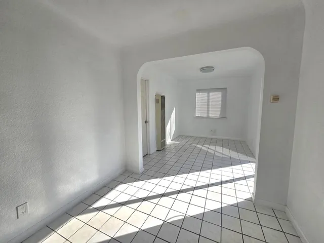 a view of a hallway with wooden shelves