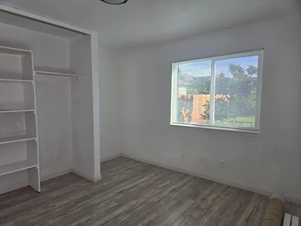 wooden floor and window in an empty room