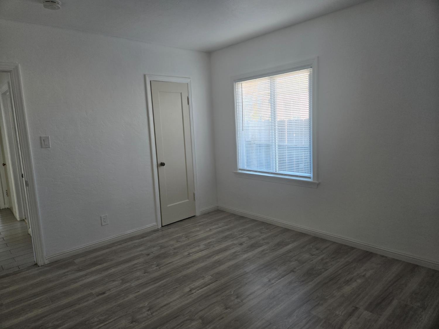 320 North Sanborn Road Salinas, CA 93905 - Photo 23 of 27 an empty room with wooden floor and windows