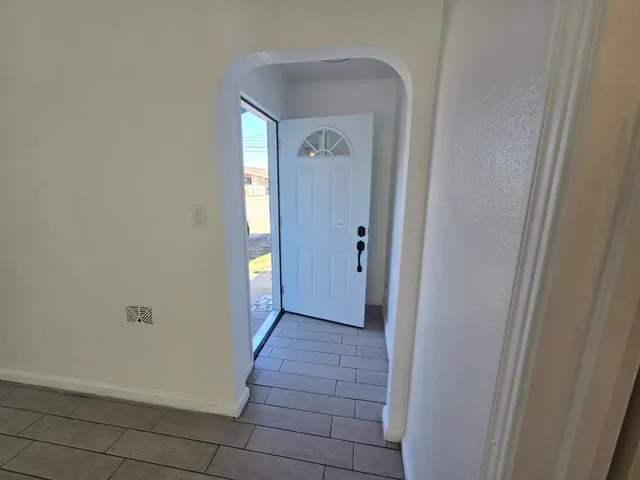 a view of a hallway with wooden floor