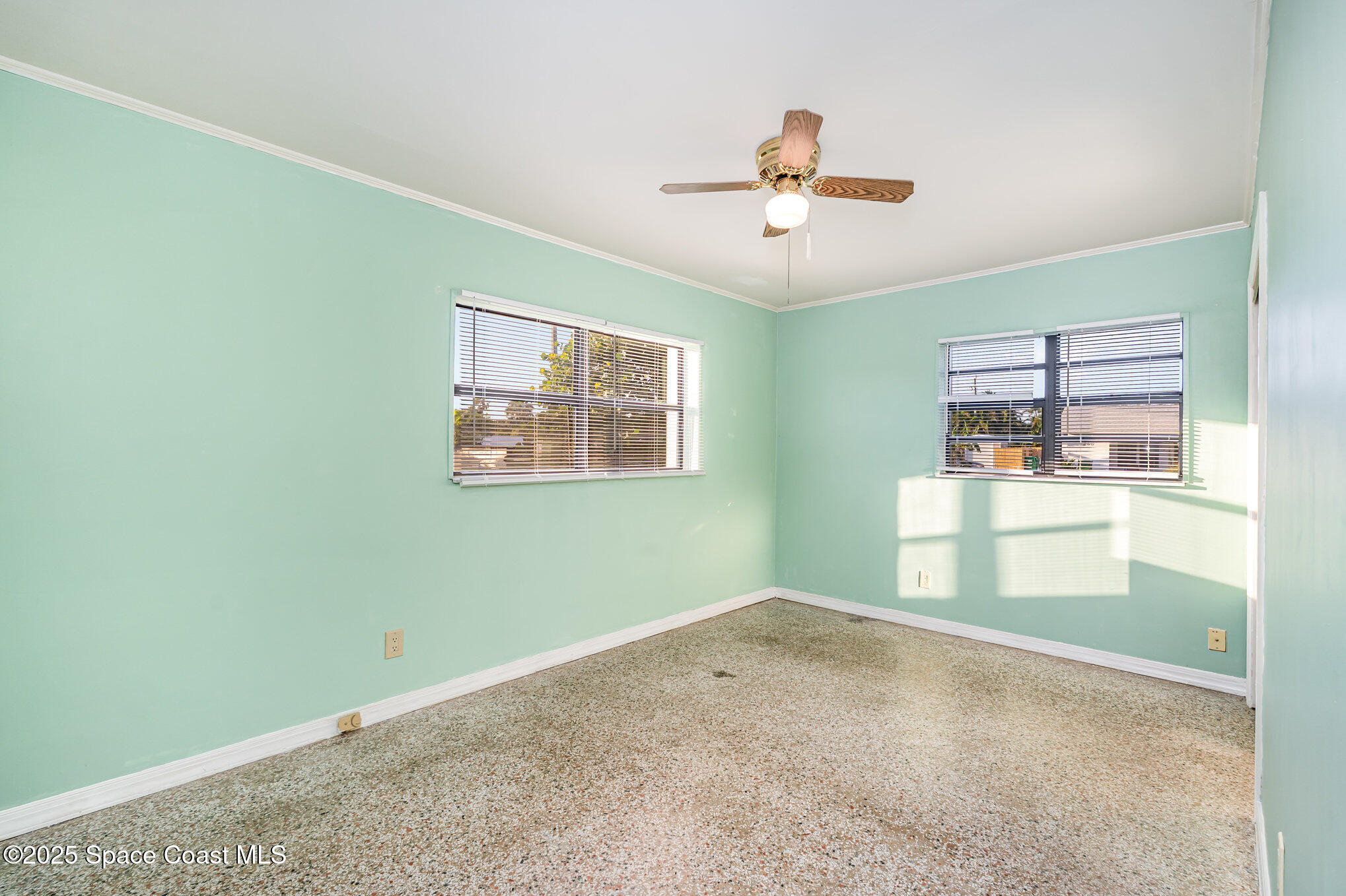 2155 Palm Avenue Indialantic, FL 32903 - Photo 11 of 15 a view of empty room with wooden floor and fan