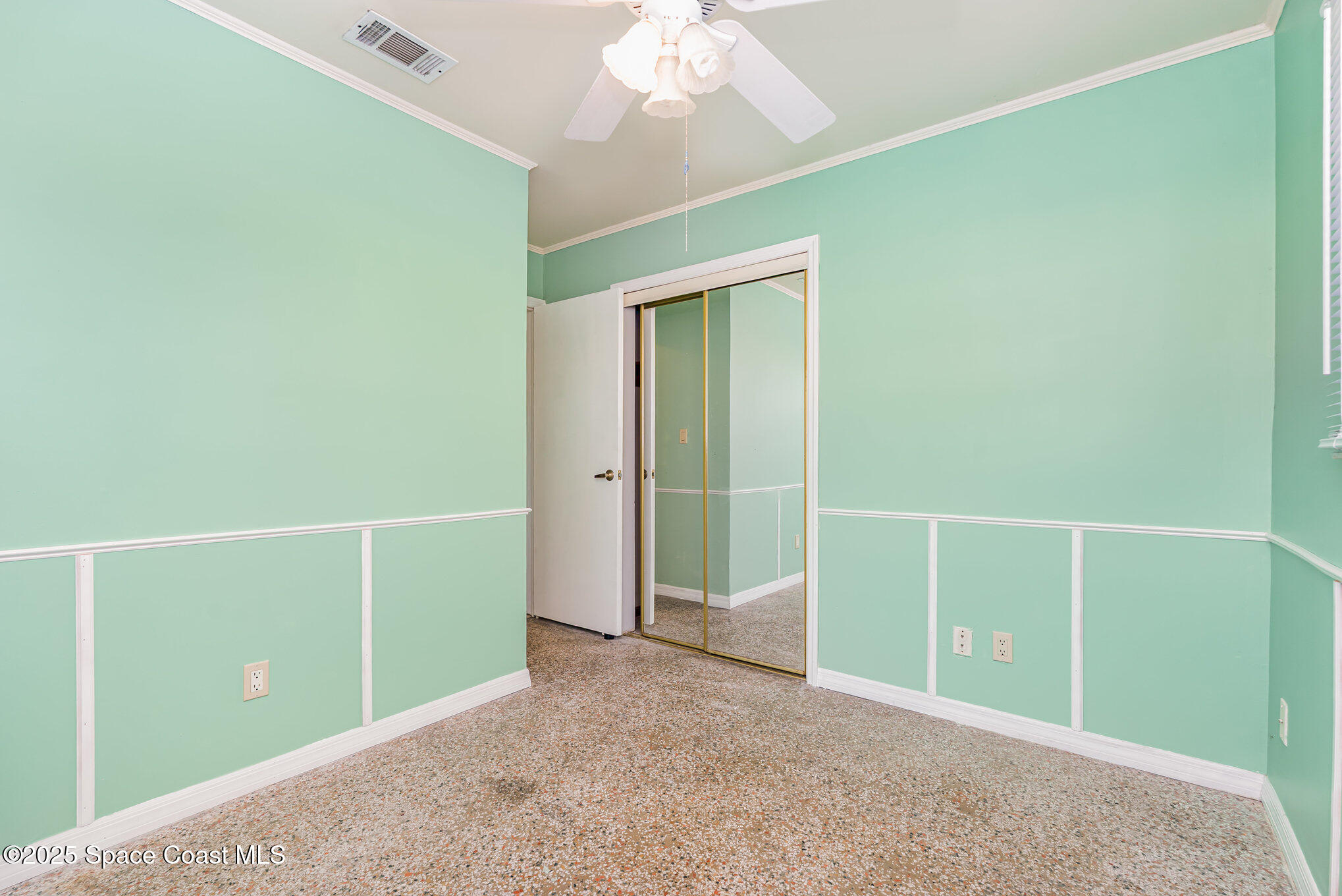 2155 Palm Avenue Indialantic, FL 32903 - Photo 13 of 15 an empty room with closet and a chandelier fan