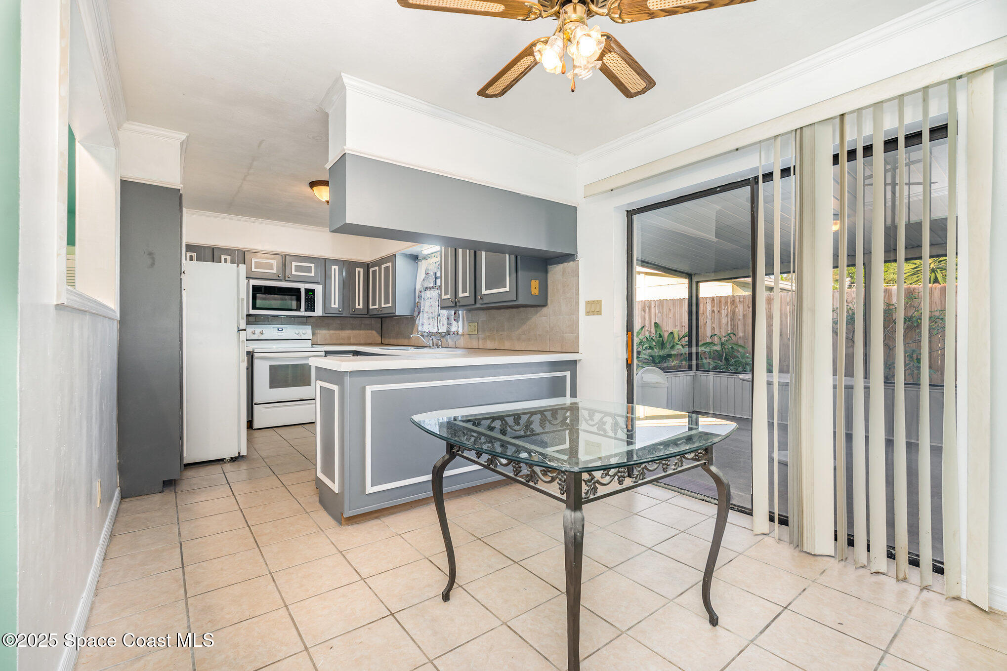2155 Palm Avenue Indialantic, FL 32903 - Photo 5 of 15 a dining room with furniture and a chandelier