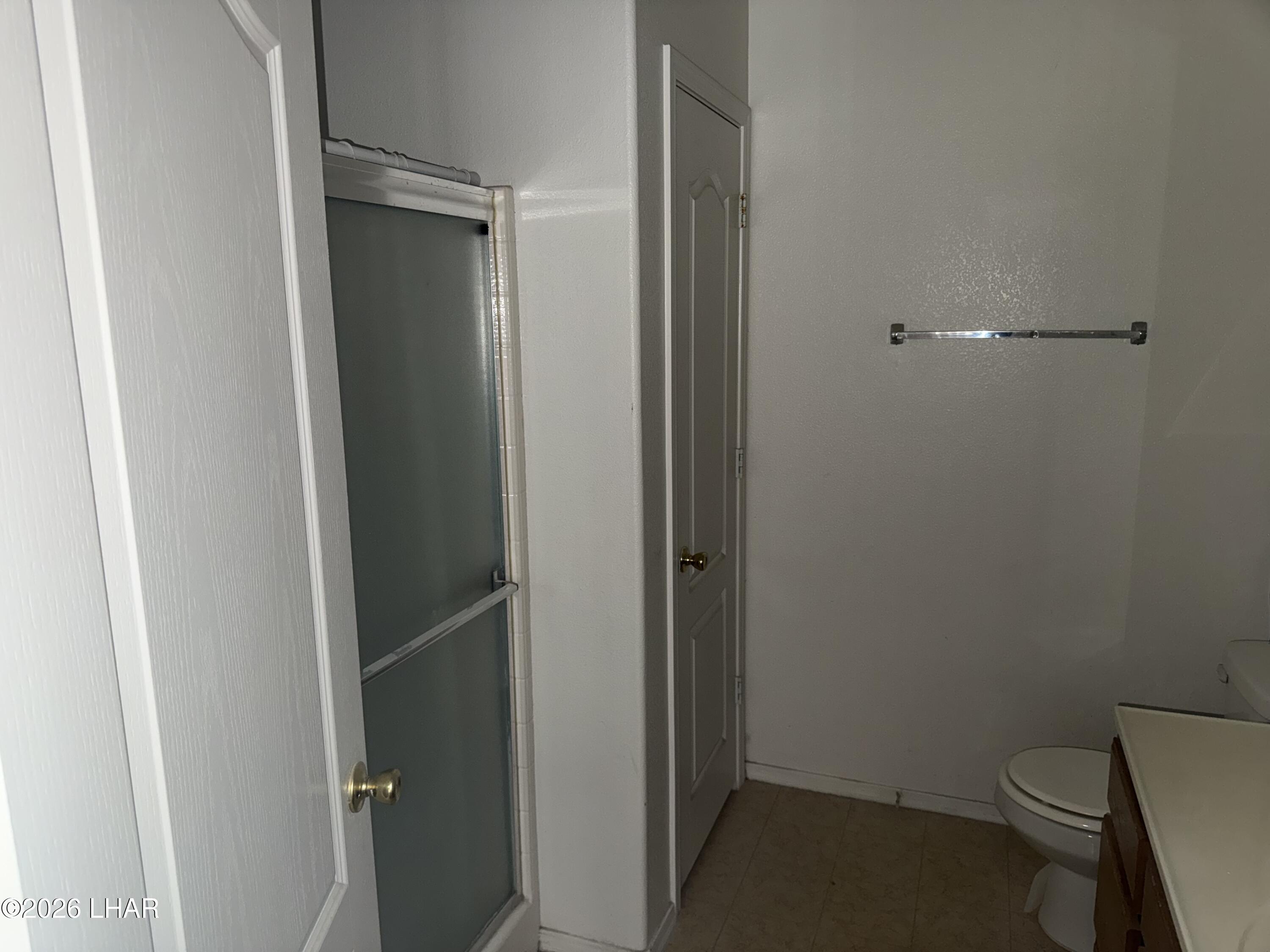 4897 South Rinaldi Drive Fort Mohave, AZ 86426 - Photo 14 of 22 a bathroom with a toilet and a shower