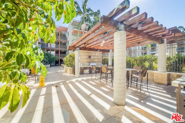 a view of a patio with a table and chairs