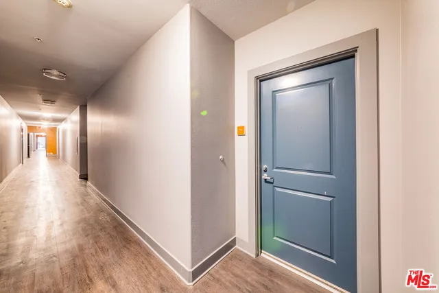a view of hallway with wooden floor