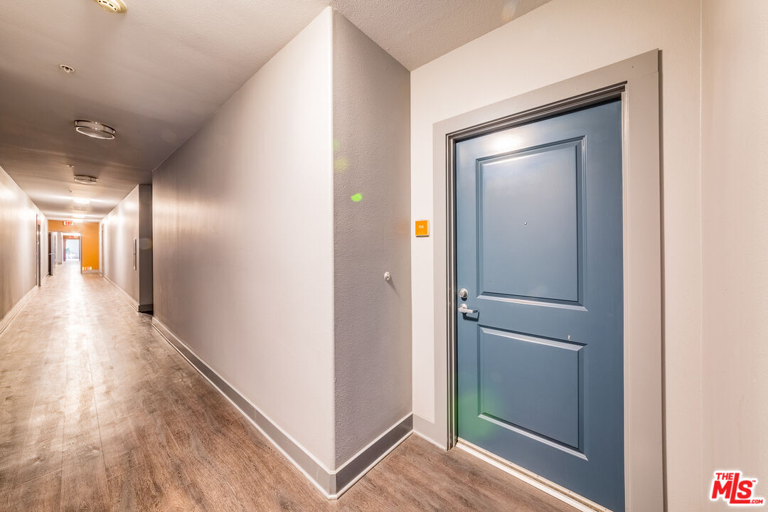 100 South Alameda Street, Unit 154 Los Angeles, CA 90012 - Photo 2 of 25 a view of hallway with wooden floor