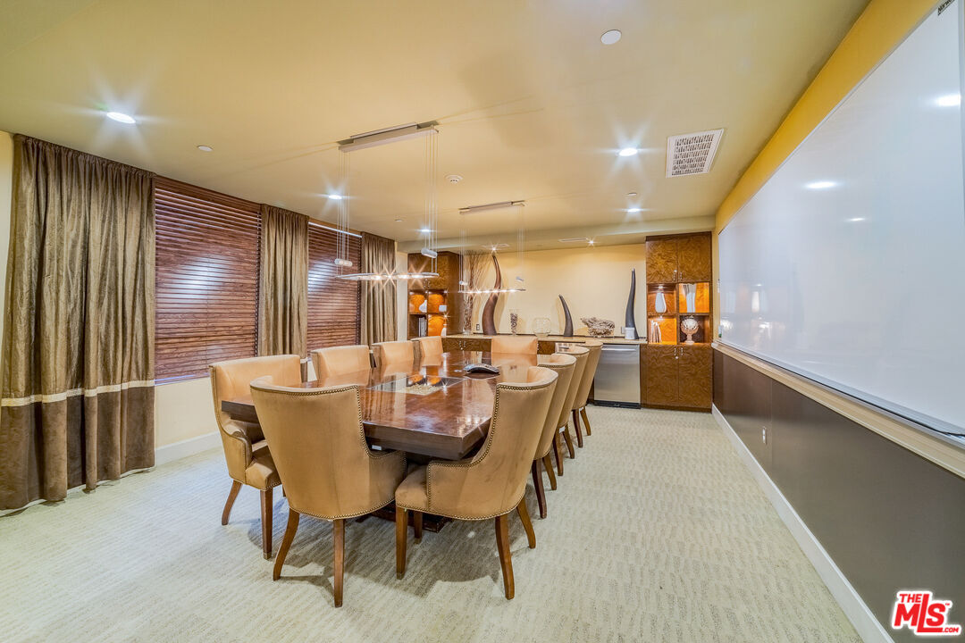 100 South Alameda Street, Unit 154 Los Angeles, CA 90012 - Photo 21 of 25 a dining room with furniture and a floor to ceiling window