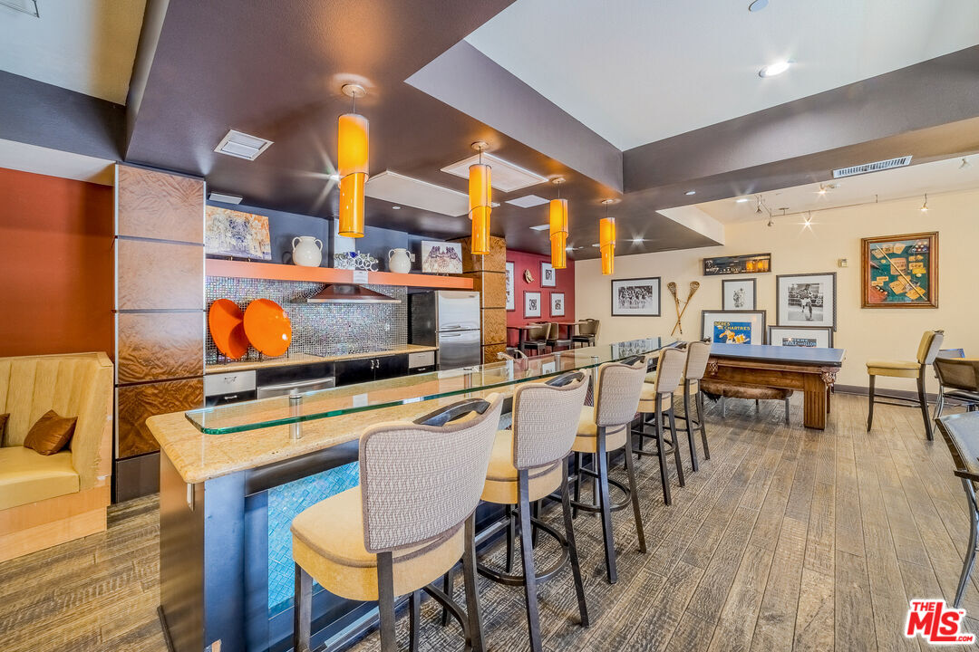 100 South Alameda Street, Unit 154 Los Angeles, CA 90012 - Photo 24 of 25 a dining room with stainless steel appliances kitchen island a table and chairs