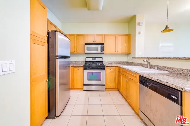 a kitchen with a sink a counter top space and cabinets