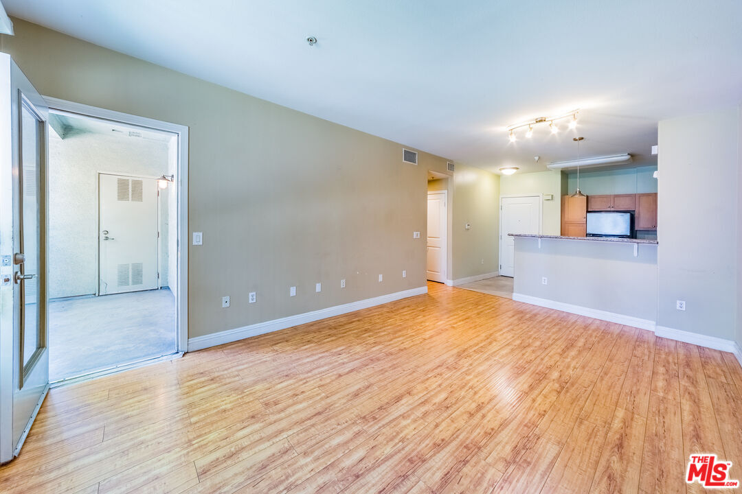 100 South Alameda Street, Unit 154 Los Angeles, CA 90012 - Photo 8 of 25 a view of a big room with wooden floor and windows