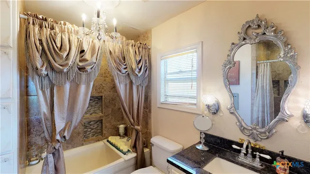 a view of a living room with furniture and a window