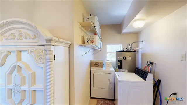 a view of storage and utility room with washer and dryer