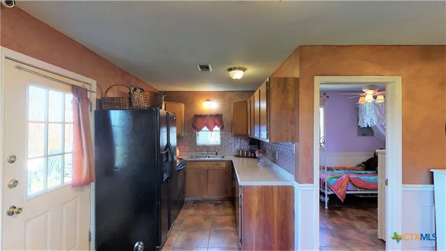 a very nice looking room with a large window and wooden floor